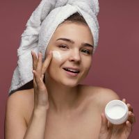 beautiful-woman-using-face-cream